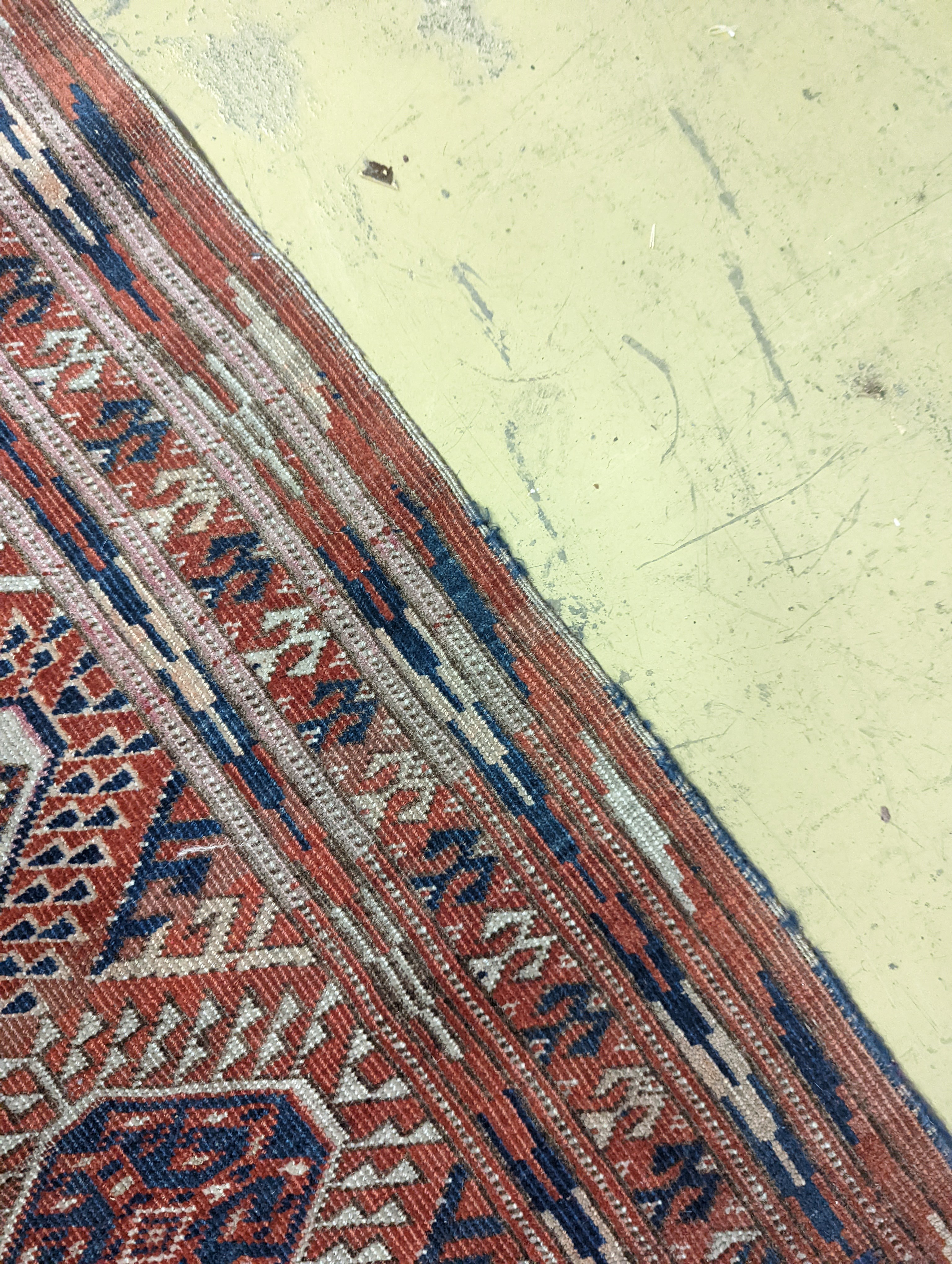A Bokhara brick red ground carpet, 350 x 230cm